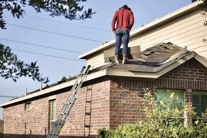 Professional roofer working on a residential roof in North Hanson